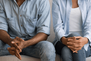 couple sitting next to each other cold body language